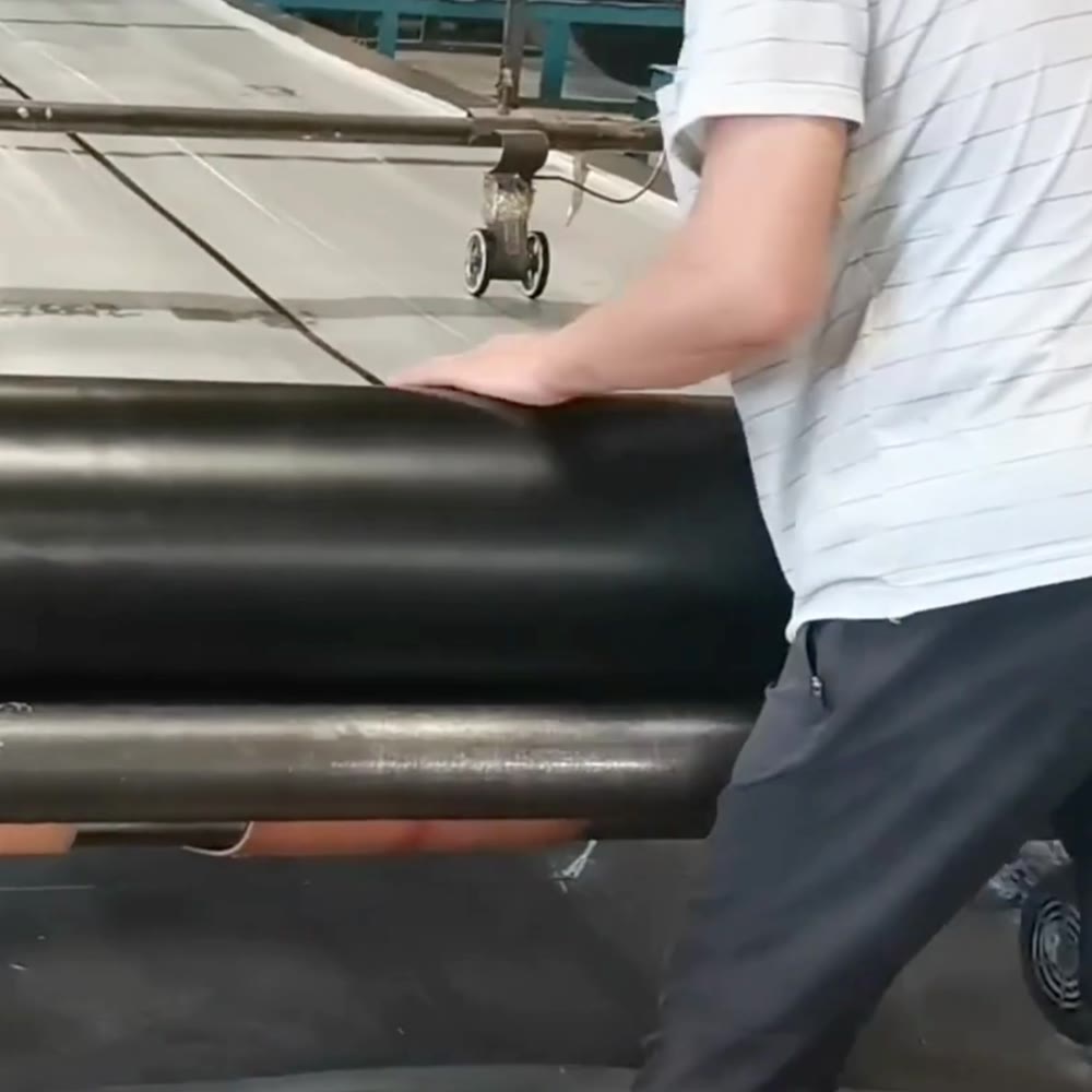 An operator handling a SoundBlanket membrane roll in production