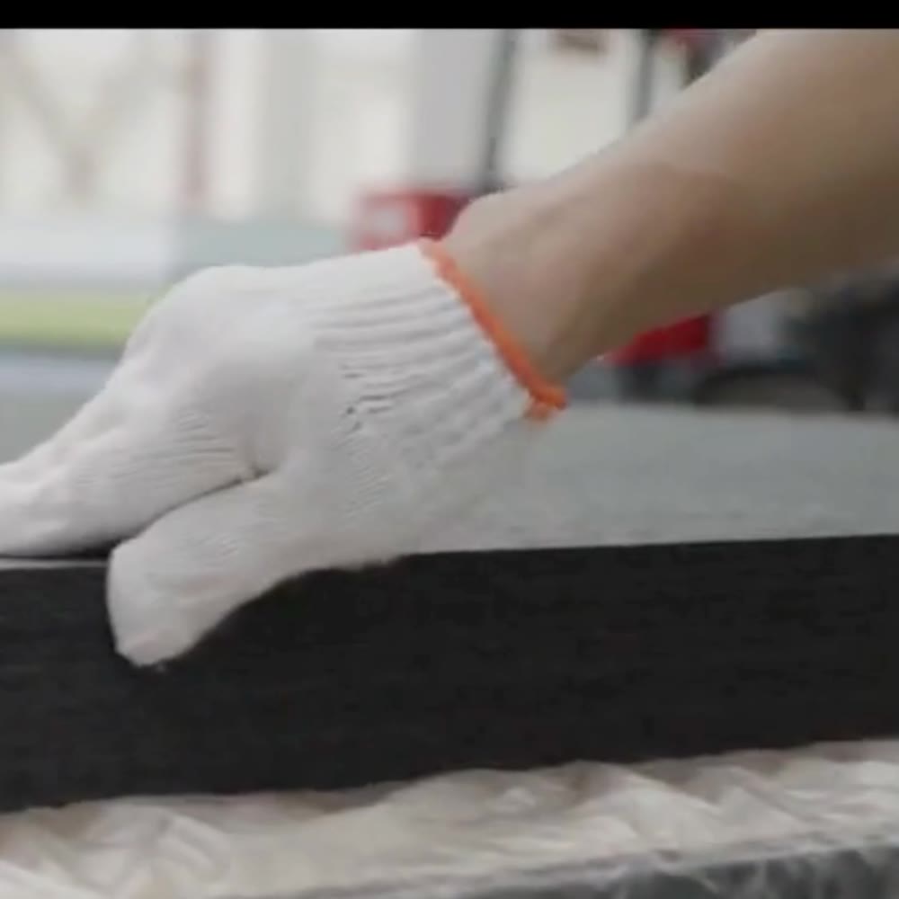 A finished acoustic panel being checked on the factory floor